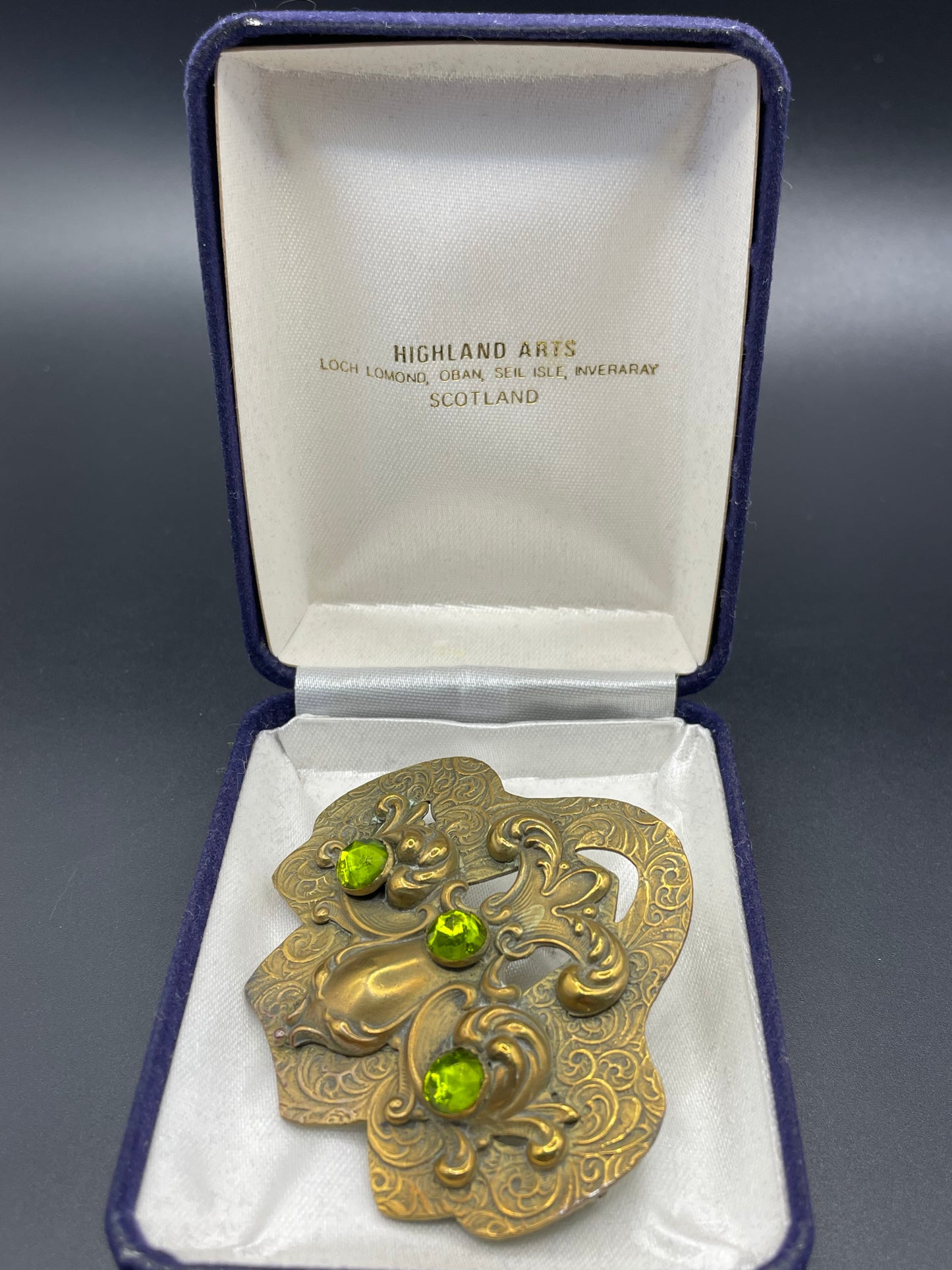 Large vintage Art Nouveau peridot green rose cut rhinestone and ornate repousse gold tone brooch sash pin