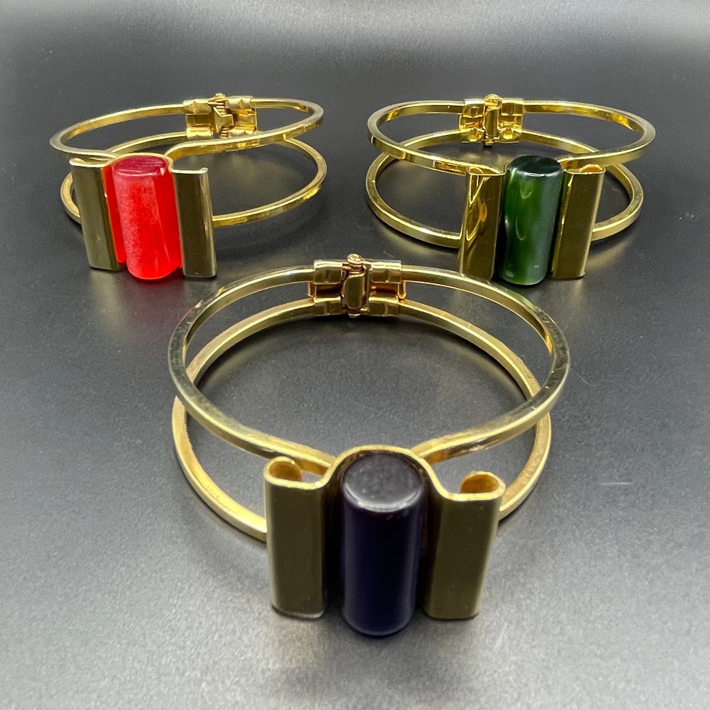 Vintage Jakob Bengel Art Deco machine age clamper bangle in shiny gold tone with a rich green galalith cylinder