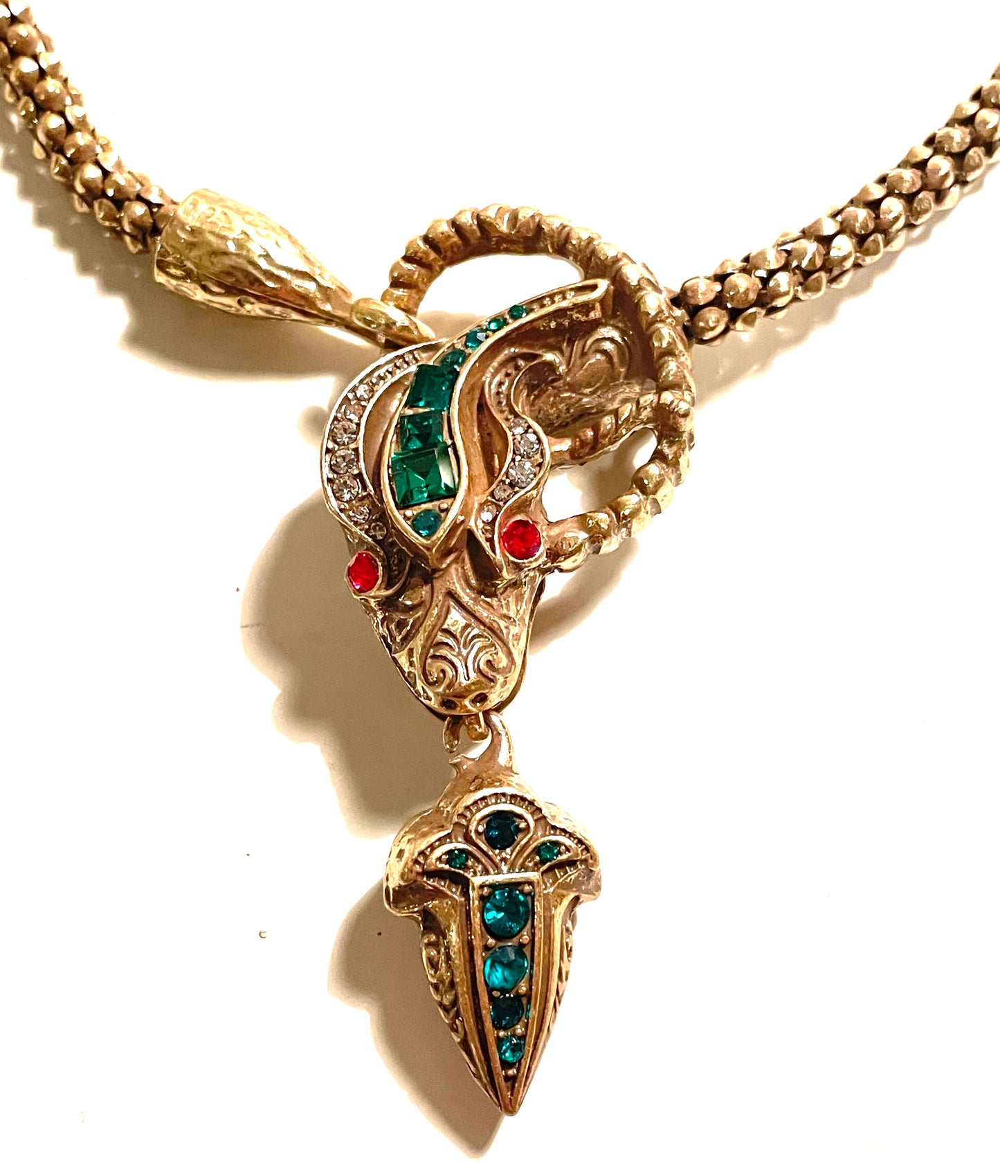 Vintage costume copy of opulent Victorian snake, serpent or dragon design lariat necklace, gold tone with red, green and clear rhinestones