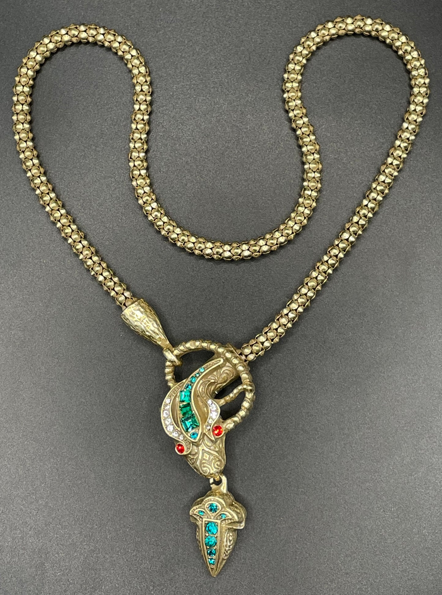 Vintage costume copy of opulent Victorian snake, serpent or dragon design lariat necklace, gold tone with red, green and clear rhinestones