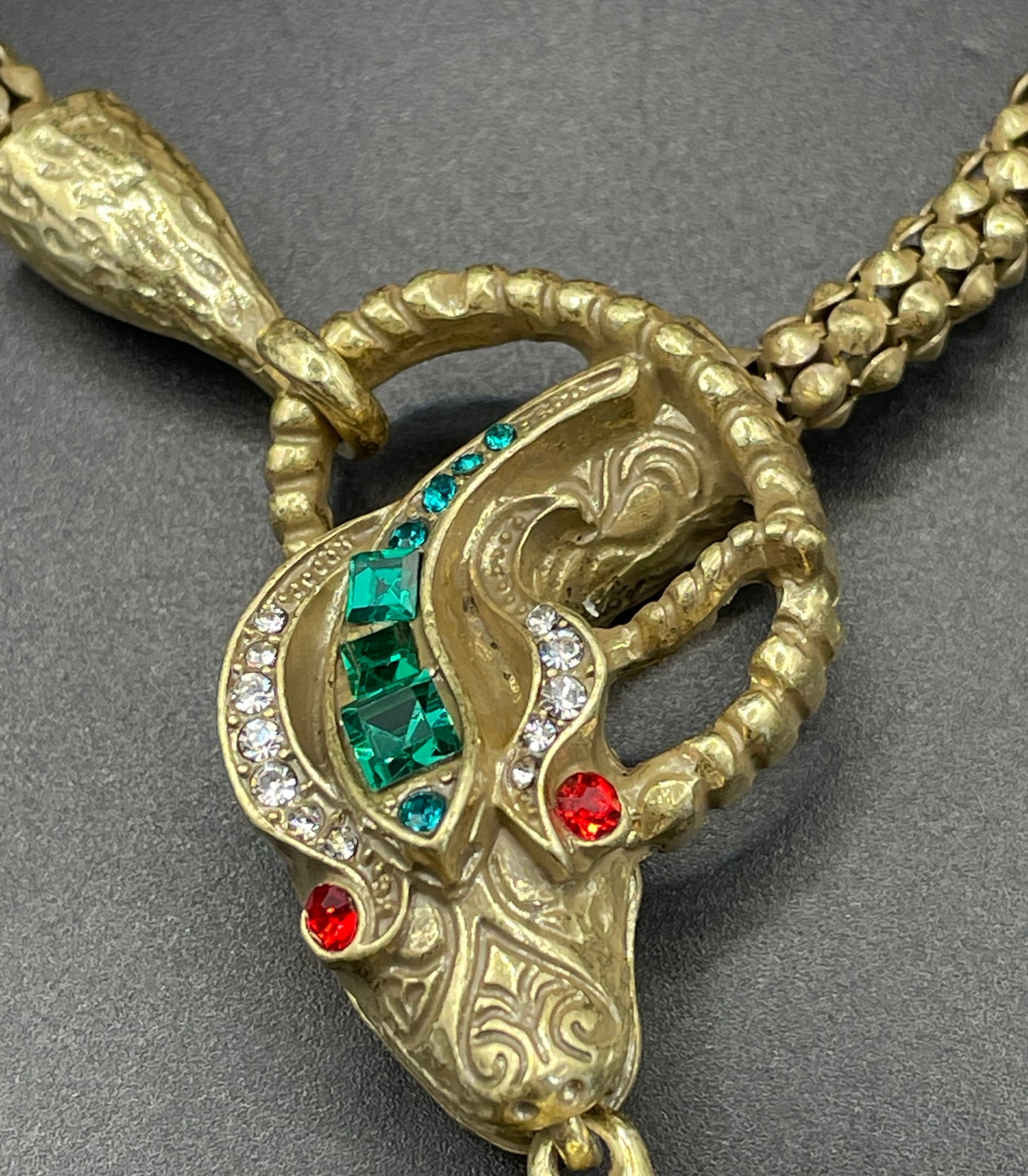 Vintage costume copy of opulent Victorian snake, serpent or dragon design lariat necklace, gold tone with red, green and clear rhinestones