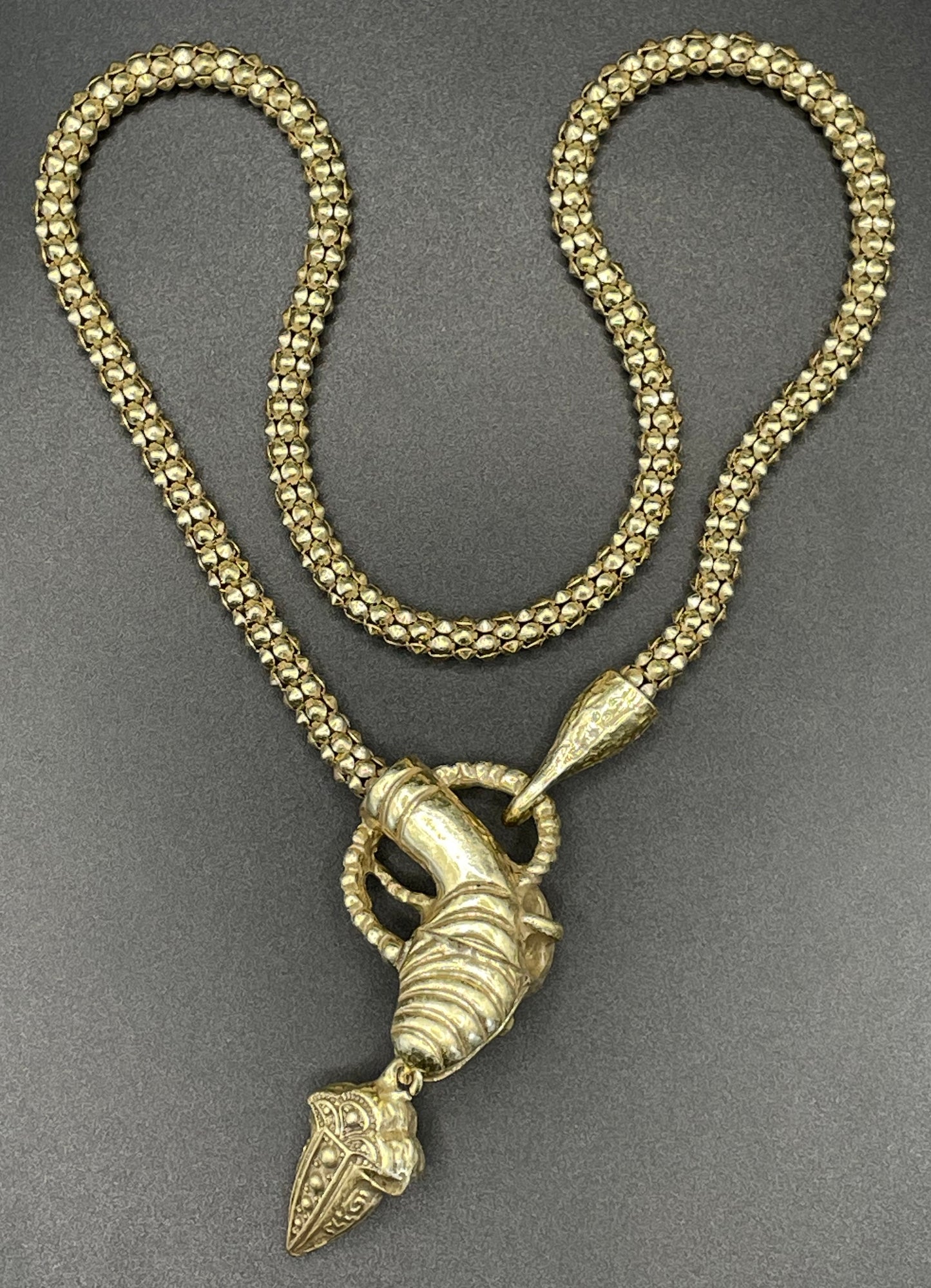 Vintage costume copy of opulent Victorian snake, serpent or dragon design lariat necklace, gold tone with red, green and clear rhinestones