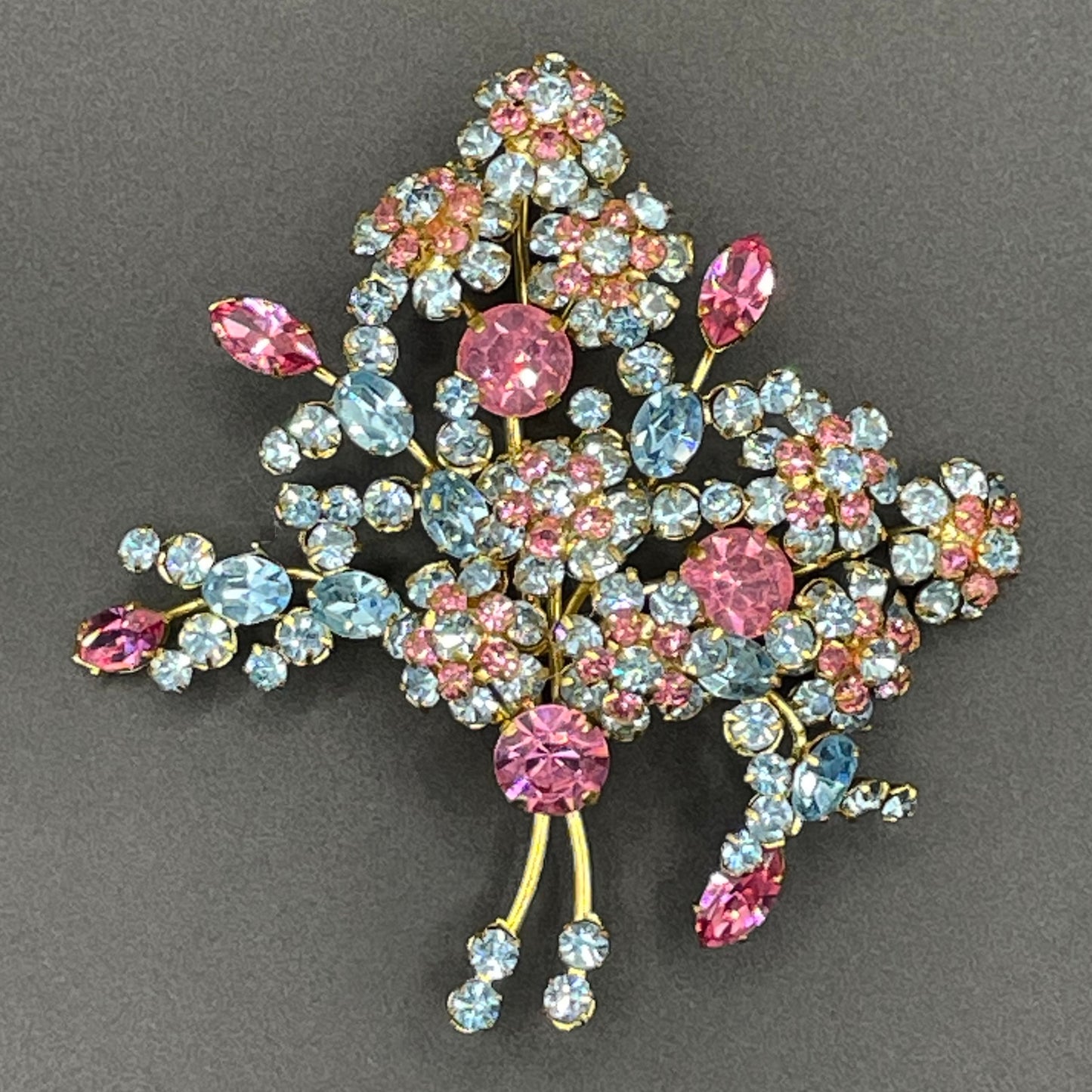Large vintage Austrian crystal pink and blue rhinestone flower bouquet brooch in gold tone, signed 'Austria'