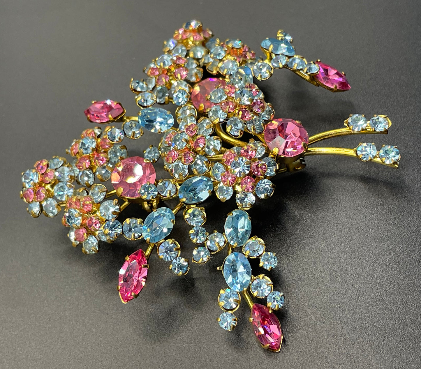 Large vintage Austrian crystal pink and blue rhinestone flower bouquet brooch in gold tone, signed 'Austria'