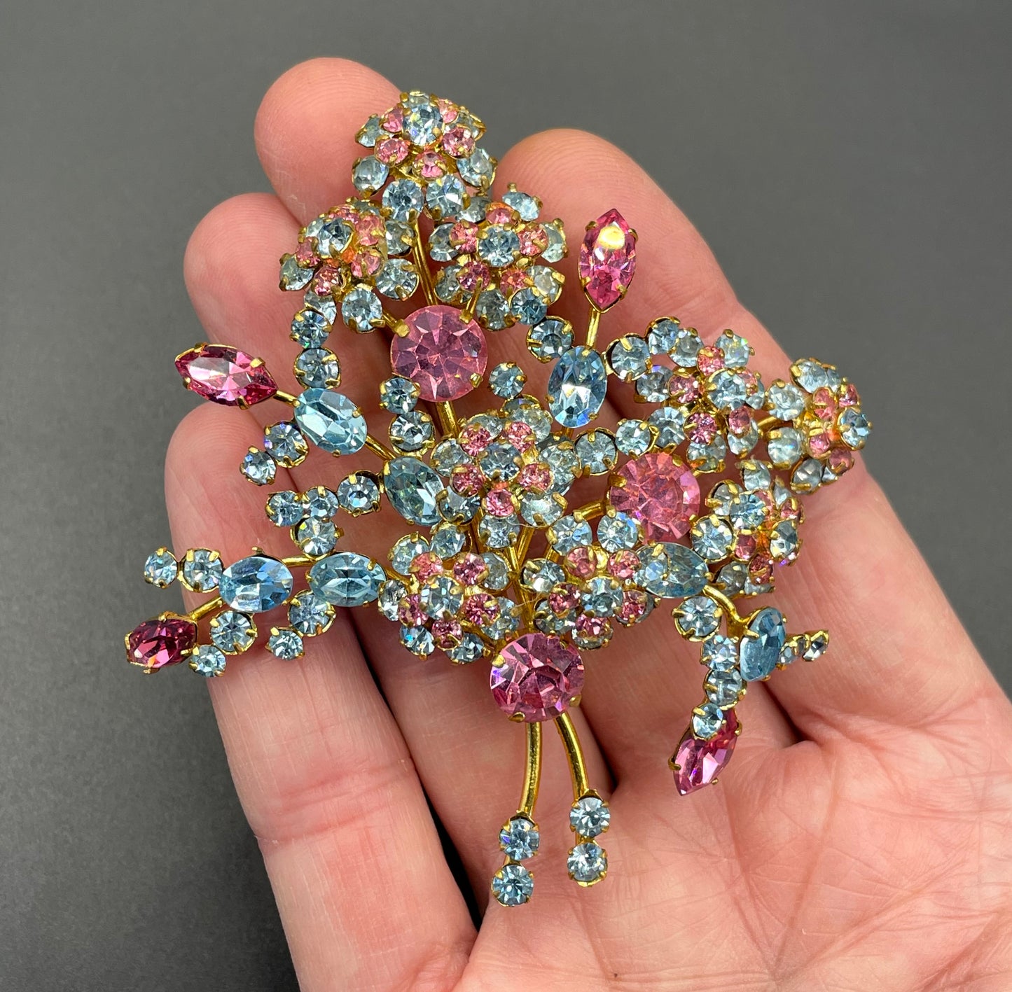 Large vintage Austrian crystal pink and blue rhinestone flower bouquet brooch in gold tone, signed 'Austria'