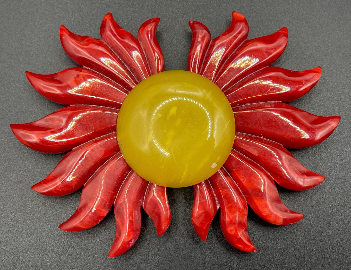 Vintage Art Deco galalith buckle with striking flame design and vibrant yellow, orange and red colours, can be worn as a statement pendant