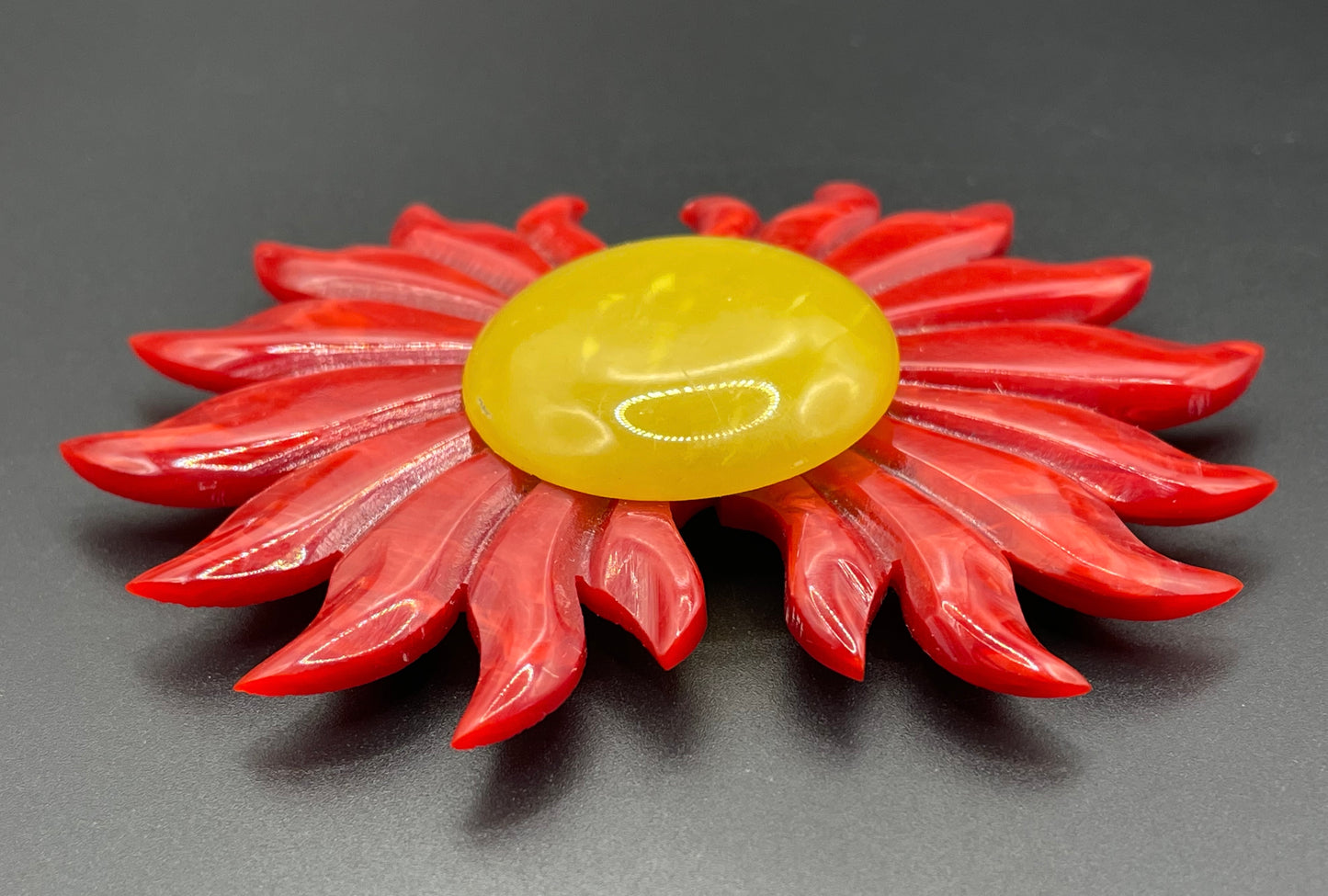 Vintage Art Deco galalith buckle with striking flame design and vibrant yellow, orange and red colours, can be worn as a statement pendant