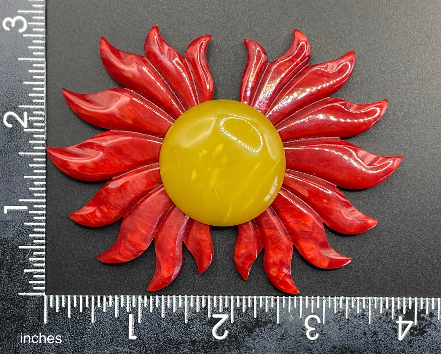 Vintage Art Deco galalith buckle with striking flame design and vibrant yellow, orange and red colours, can be worn as a statement pendant