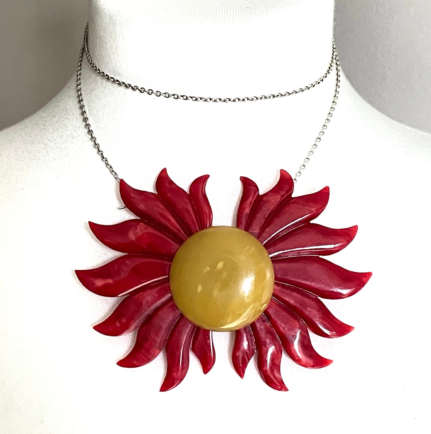 Vintage Art Deco galalith buckle with striking flame design and vibrant yellow, orange and red colours, can be worn as a statement pendant
