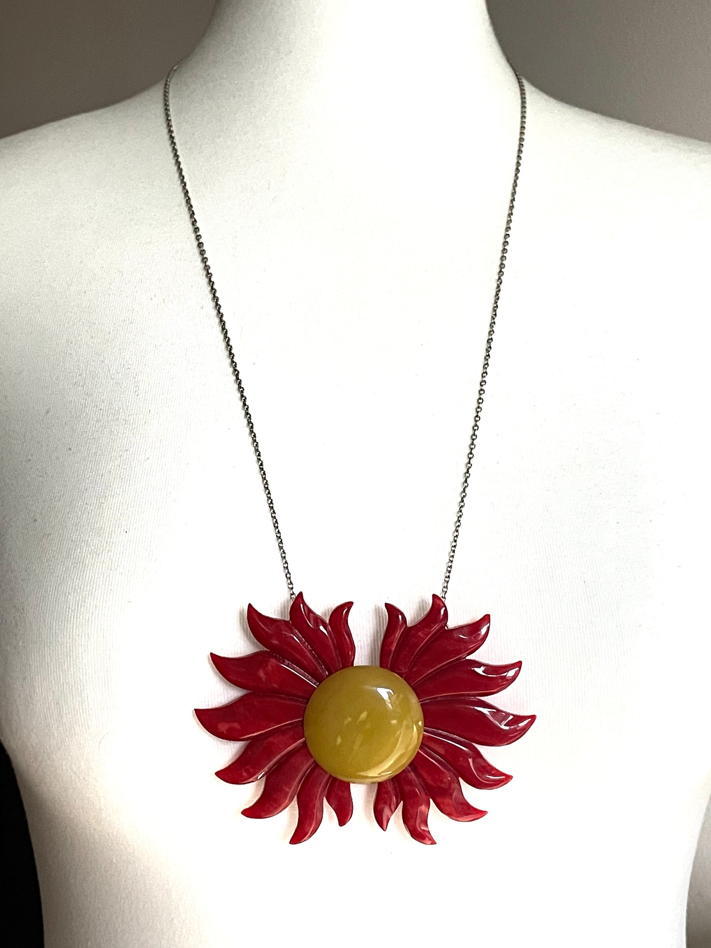 Vintage Art Deco galalith buckle with striking flame design and vibrant yellow, orange and red colours, can be worn as a statement pendant