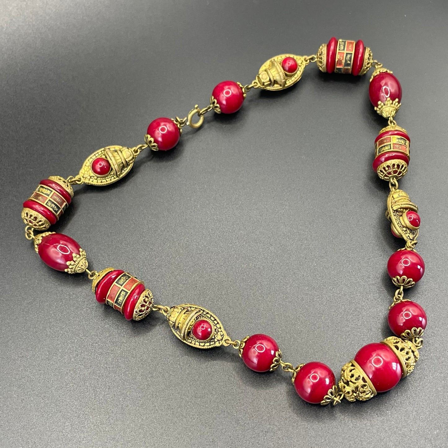 Vintage Neiger Brothers Art Deco heavy red glass bead necklace with beautiful gold tone features - by Max Neiger
