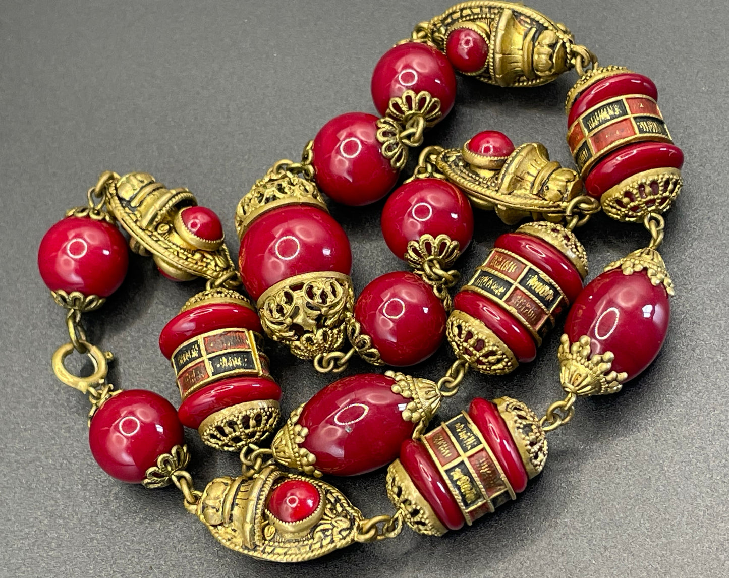 Vintage Neiger Brothers Art Deco heavy red glass bead necklace with beautiful gold tone features - by Max Neiger