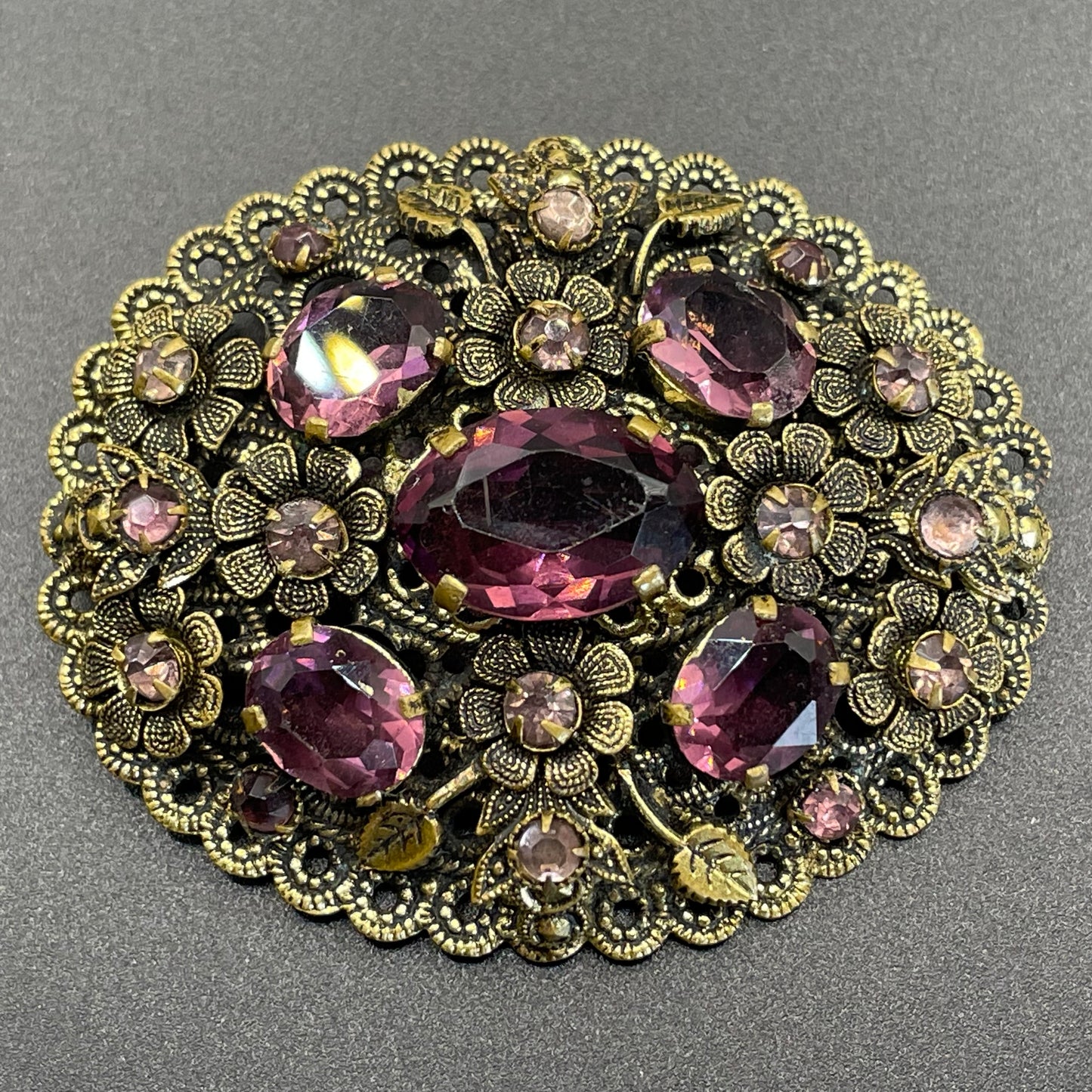 Large vintage Neiger style Art Deco amethyst purple glass rhinestone Czech brooch in antique gold tone filigree, floral design