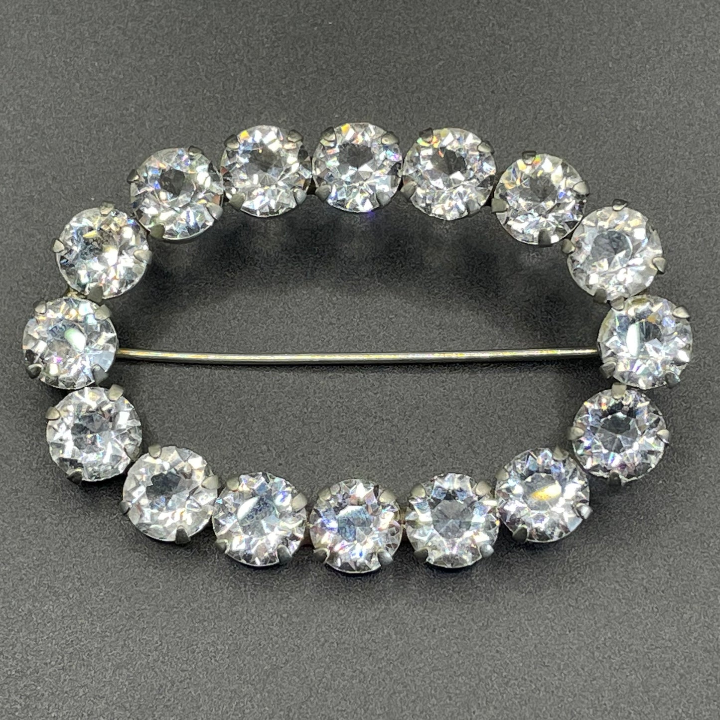 Large antique Victorian to Edwardian ice clear paste crystal rhinestone oval ring brooch with open backed stones, set in silver tone