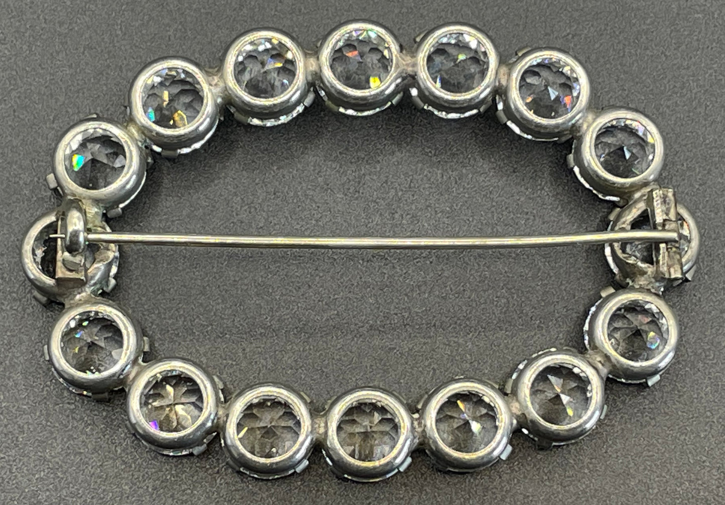 Large antique Victorian to Edwardian ice clear paste crystal rhinestone oval ring brooch with open backed stones, set in silver tone