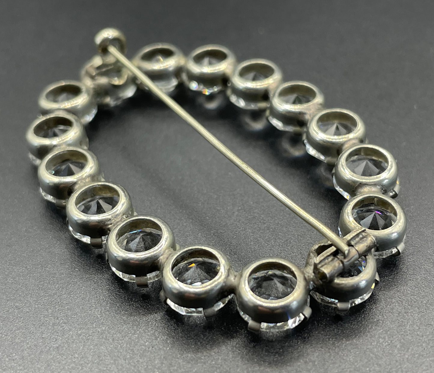 Large antique Victorian to Edwardian ice clear paste crystal rhinestone oval ring brooch with open backed stones, set in silver tone
