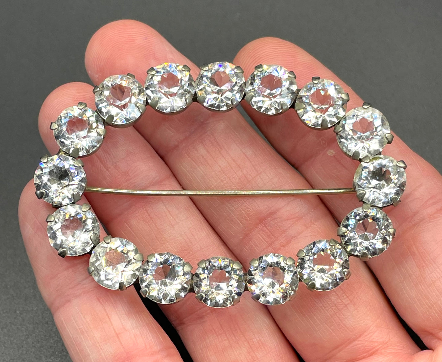 Large antique Victorian to Edwardian ice clear paste crystal rhinestone oval ring brooch with open backed stones, set in silver tone