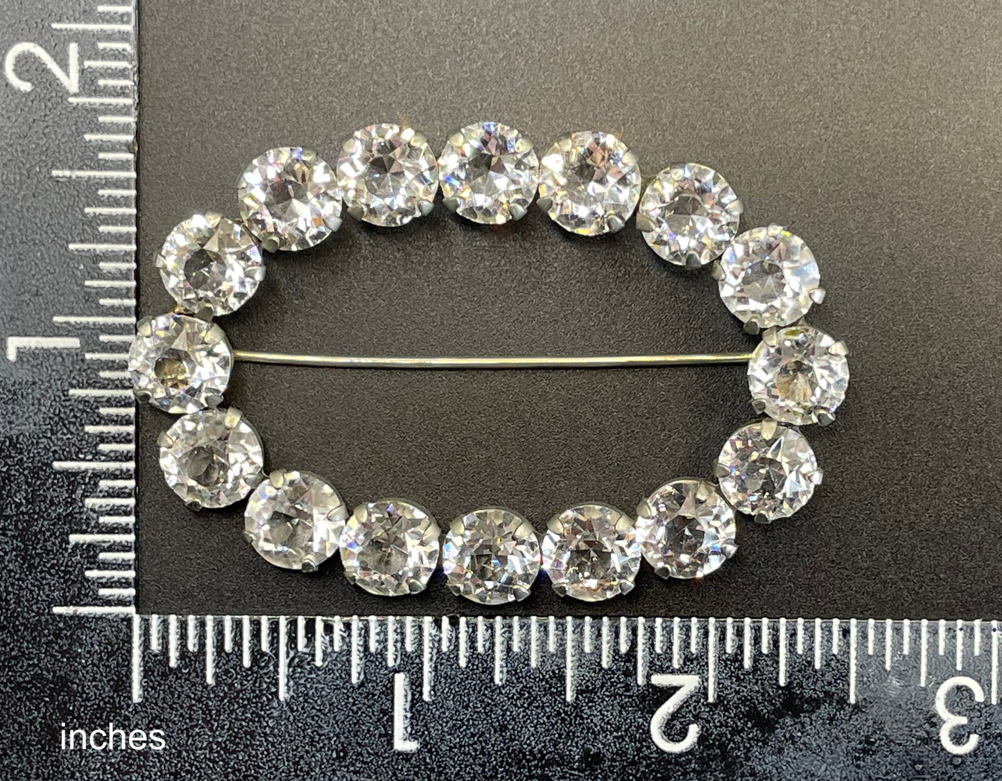 Large antique Victorian to Edwardian ice clear paste crystal rhinestone oval ring brooch with open backed stones, set in silver tone