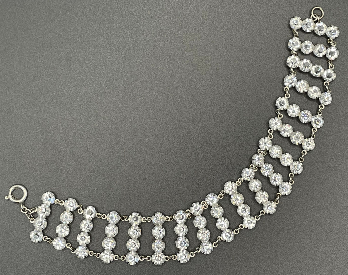 Vintage ice clear paste Art Deco tennis cocktail bracelet with rhinestone set open-backed in silver tone