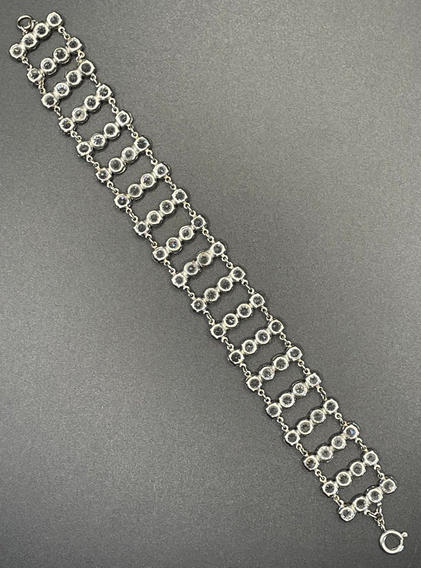 Vintage ice clear paste Art Deco tennis cocktail bracelet with rhinestone set open-backed in silver tone