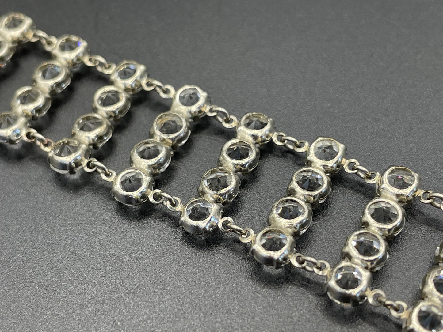 Vintage ice clear paste Art Deco tennis cocktail bracelet with rhinestone set open-backed in silver tone
