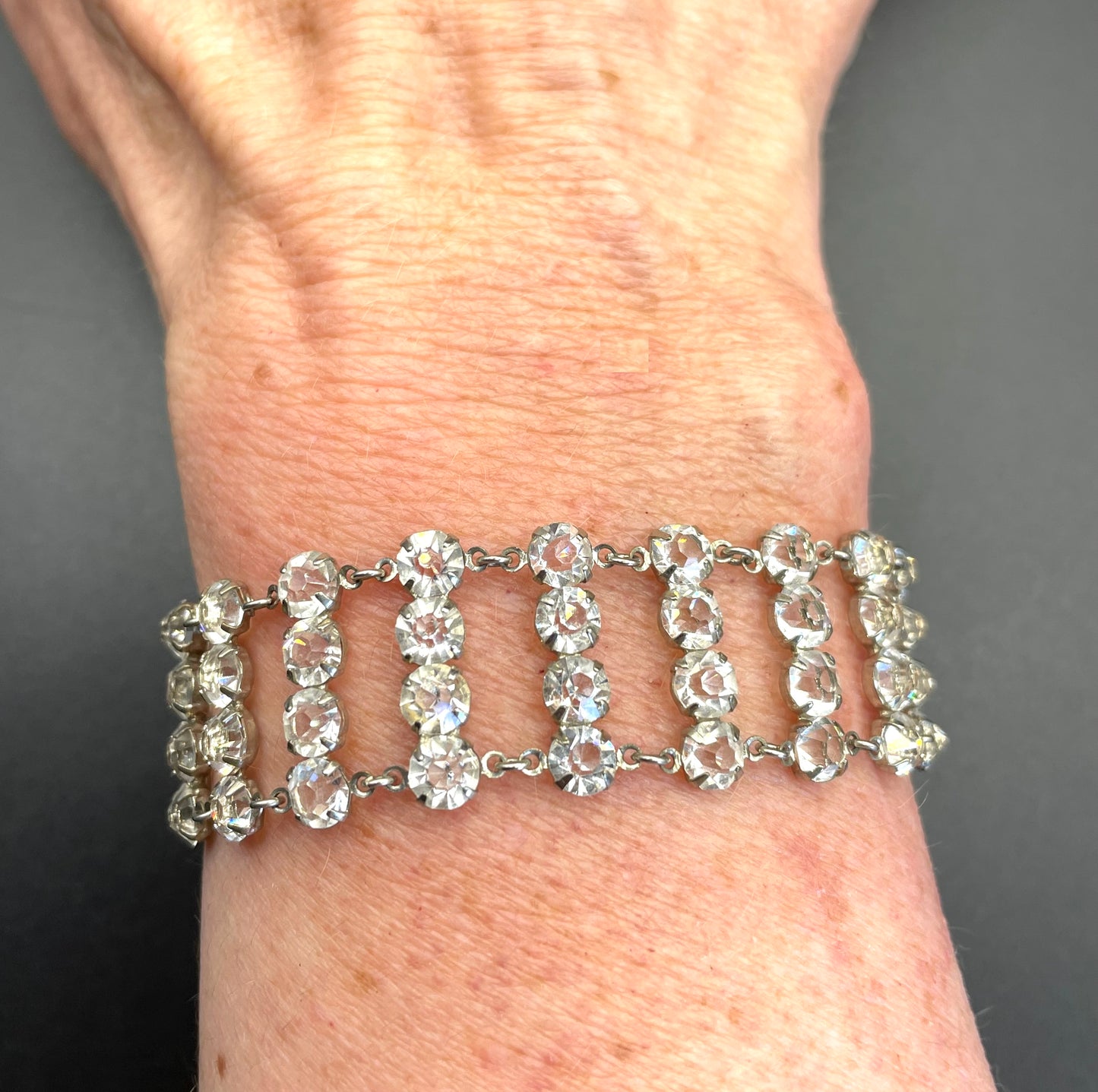 Vintage ice clear paste Art Deco tennis cocktail bracelet with rhinestone set open-backed in silver tone