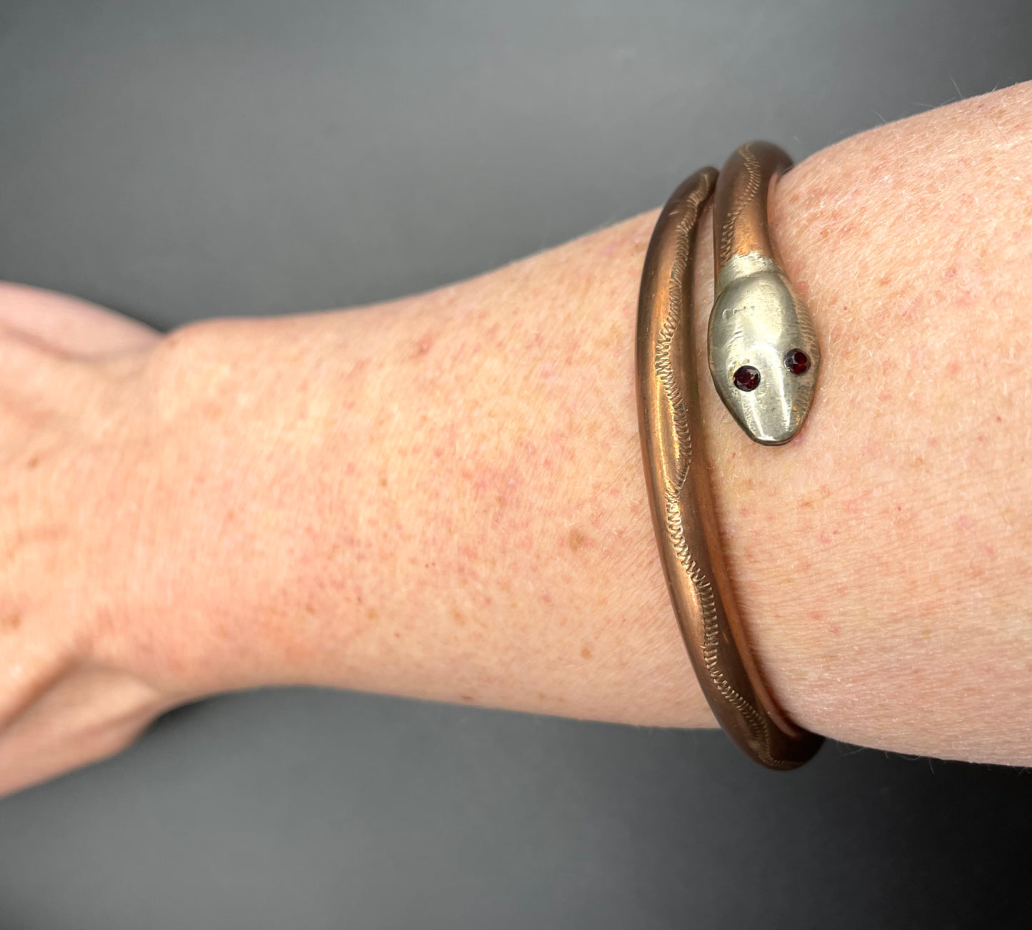 Vintage Art Deco 1920s to 1930s heavy copper snake arm bangle with silver tone head and garnet eyes, pretty hand engraving / tooling