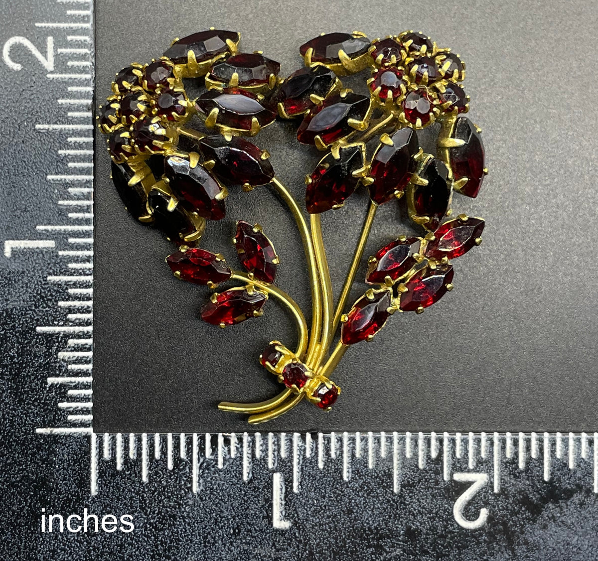 Vintage red garnet glass flower bouquet brooch, with rhinestones set open-backed in gold tone