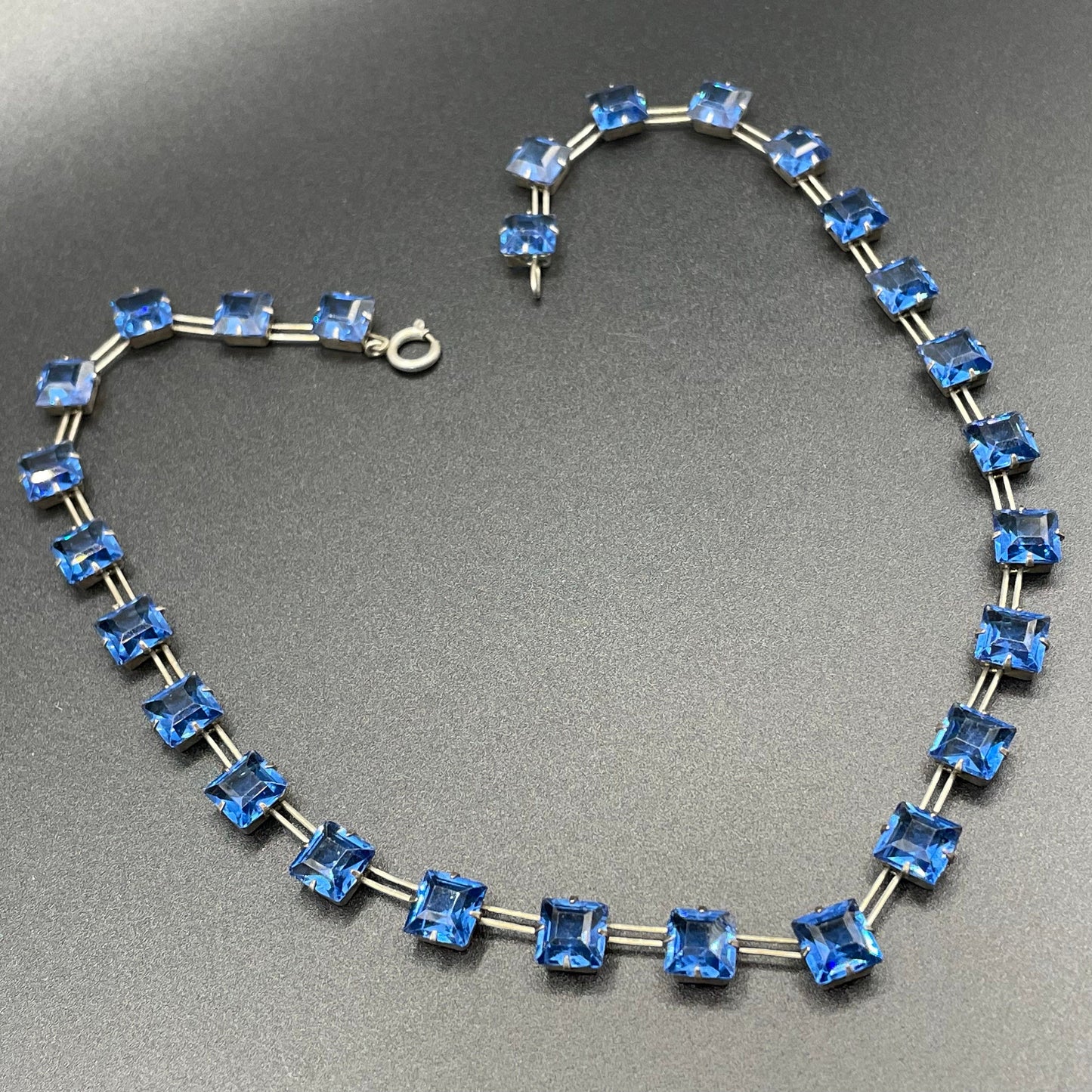 Vintage Sterling silver Art Deco bezel set sapphire blue crystal riviere necklace, open-backed princess cut (square) rhinestones, hallmarked, by W H Collins