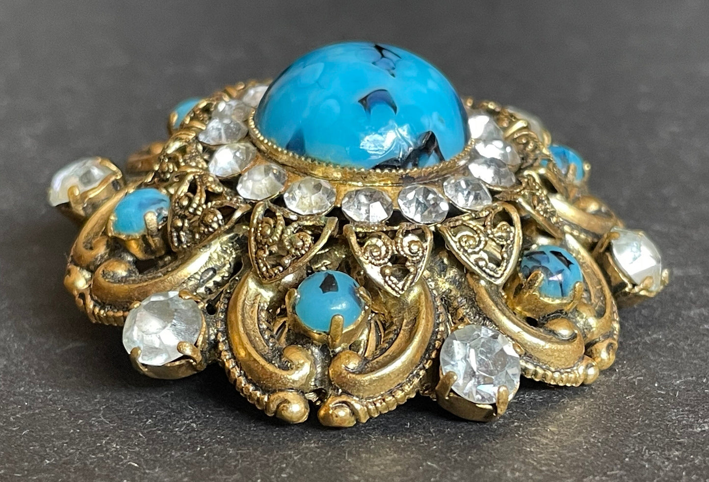 Large vintage Art Deco faux turquoise glass cabochon, clear paste rhinestone and gold tone filigree Czech flower brooch