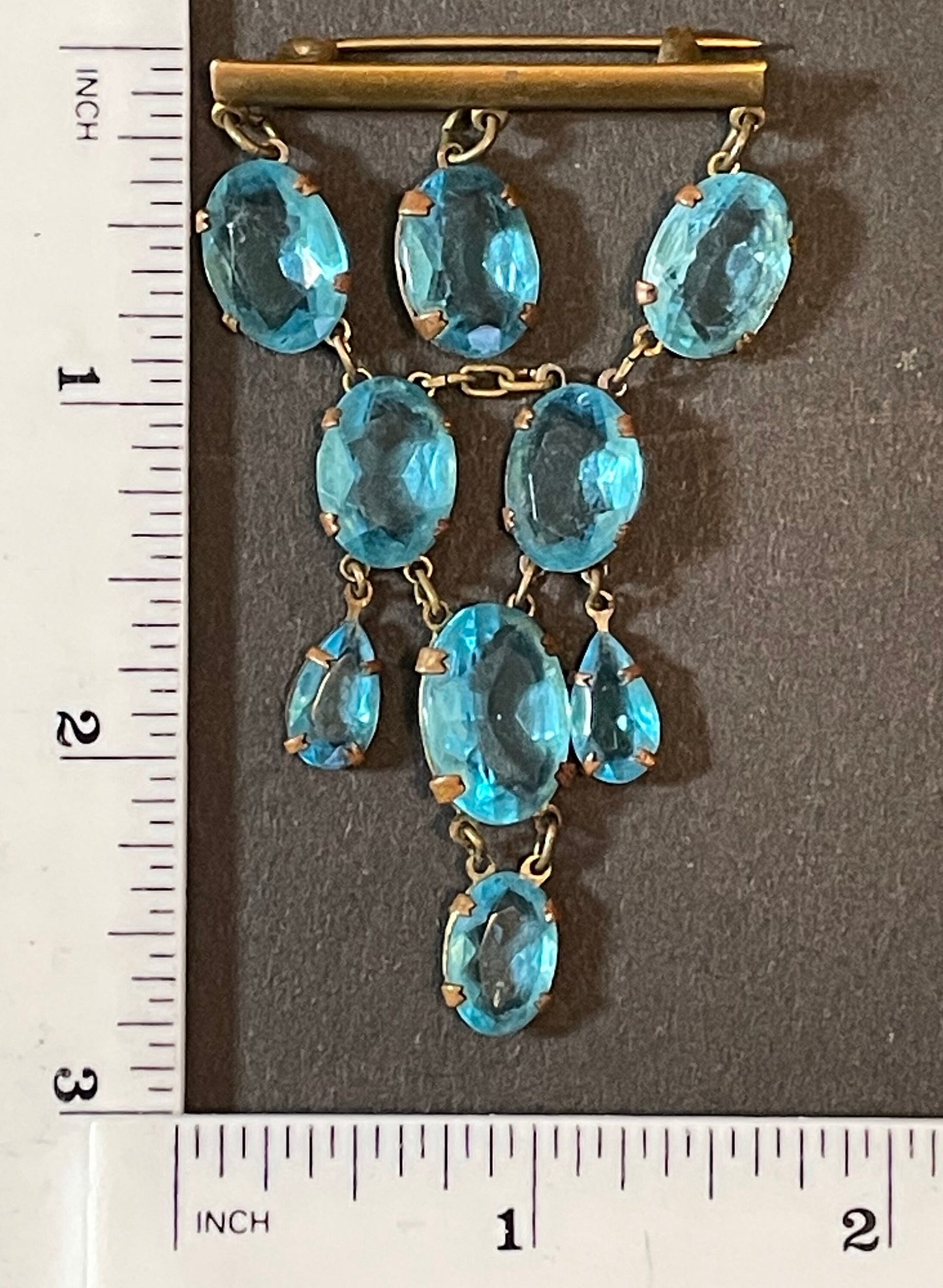 Vintage Art Deco aqua blue paste festoon dangle brooch with bezel set, open backed aquamarine coloured crystals set in antique gold tone