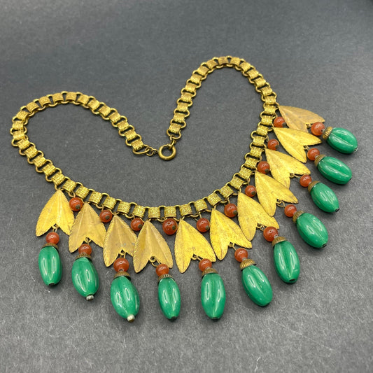 Vintage early Miriam Haskell jade green and orange poured glass beaded and gold tone Egyptian revival fringe necklace with bookchain links