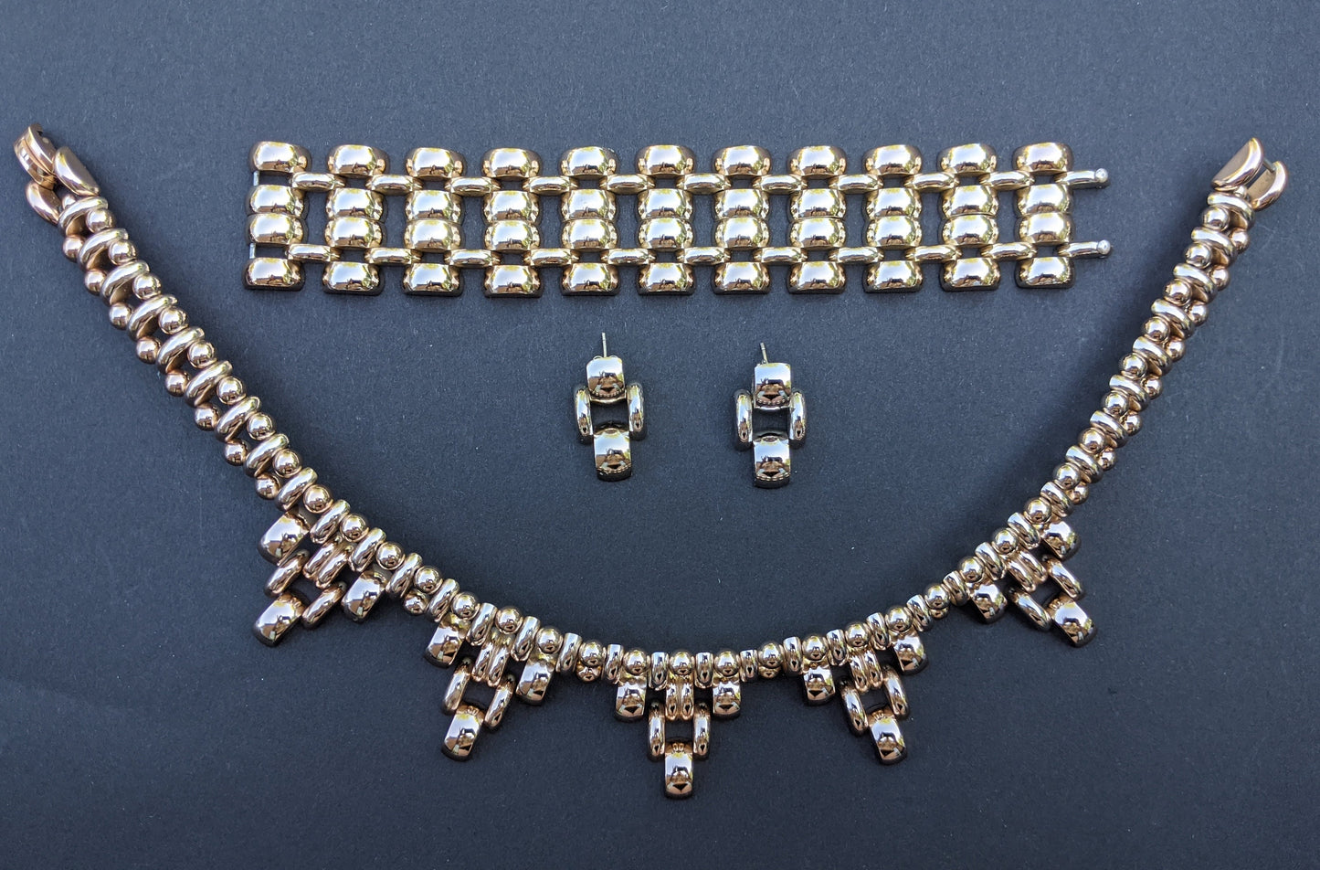 Vintage Art Deco style machine age geometric light gold tone triangle collar necklace, tank track bracelet and earrings set signed de Farre