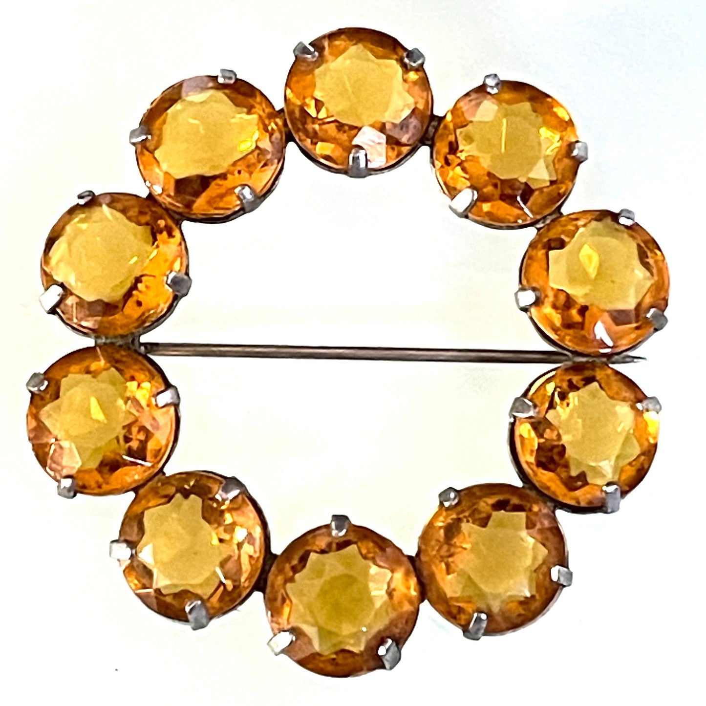 Vintage Art Deco bezel set sunshine coloured citrine yellow / orange crystal riviere circle brooch, open-backed rhinestones in silver tone