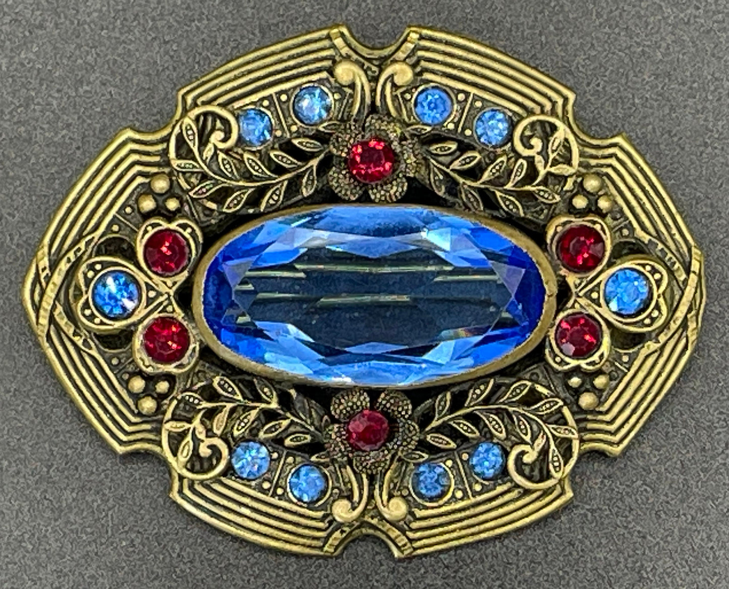 Large vintage Art Deco sapphire blue and bright ruby red rhinestone and ornate gold tone floral design Czech brooch, Neiger style