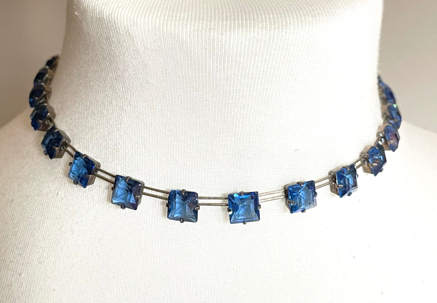 Vintage Sterling silver Art Deco bezel set sapphire blue crystal riviere necklace, open-backed princess cut (square) rhinestones, hallmarked, by W H Collins