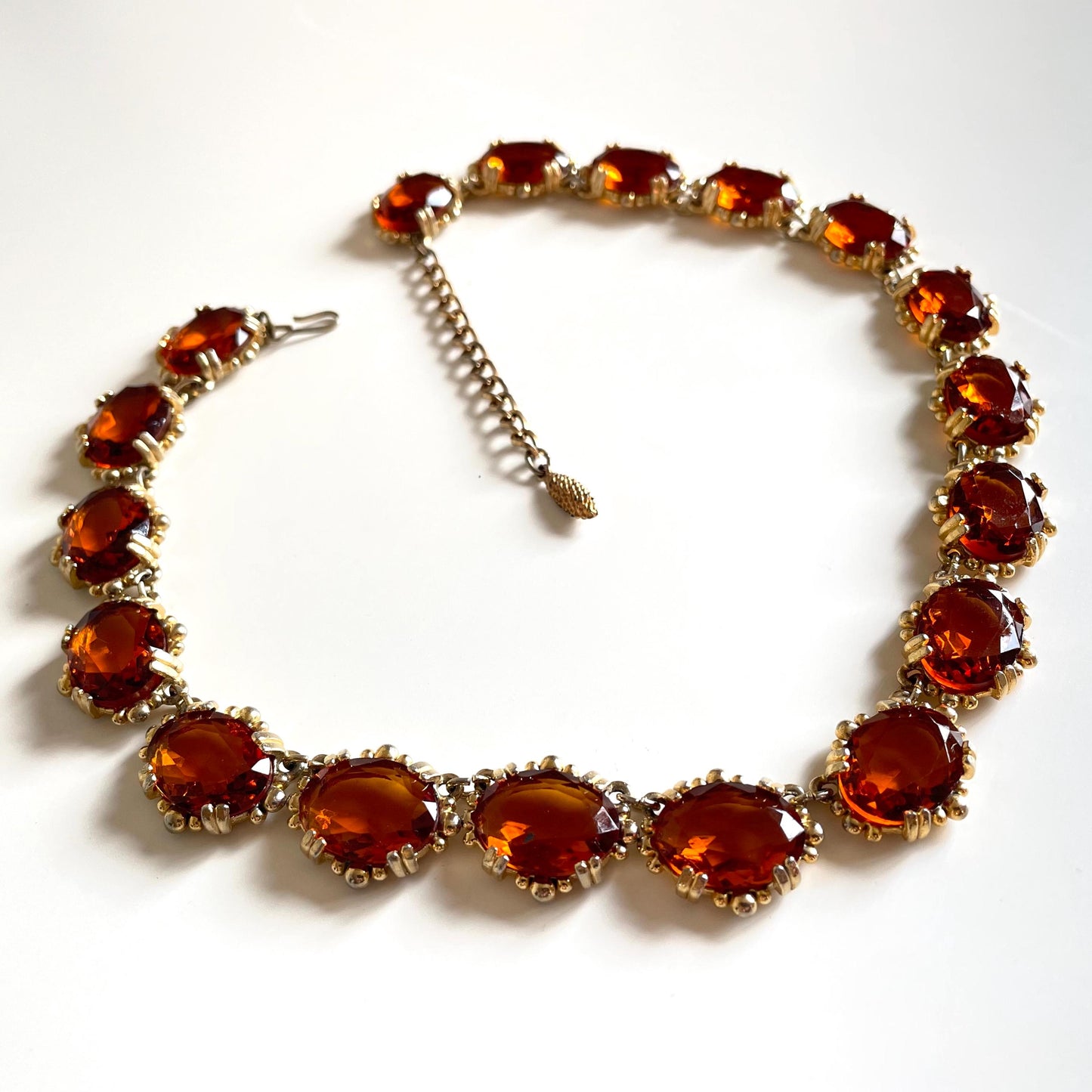 Vintage bright orange topaz / citrine yellow riviere necklace, made by Sphinx, bezel set, open-backed stones in ornate gold tone setting