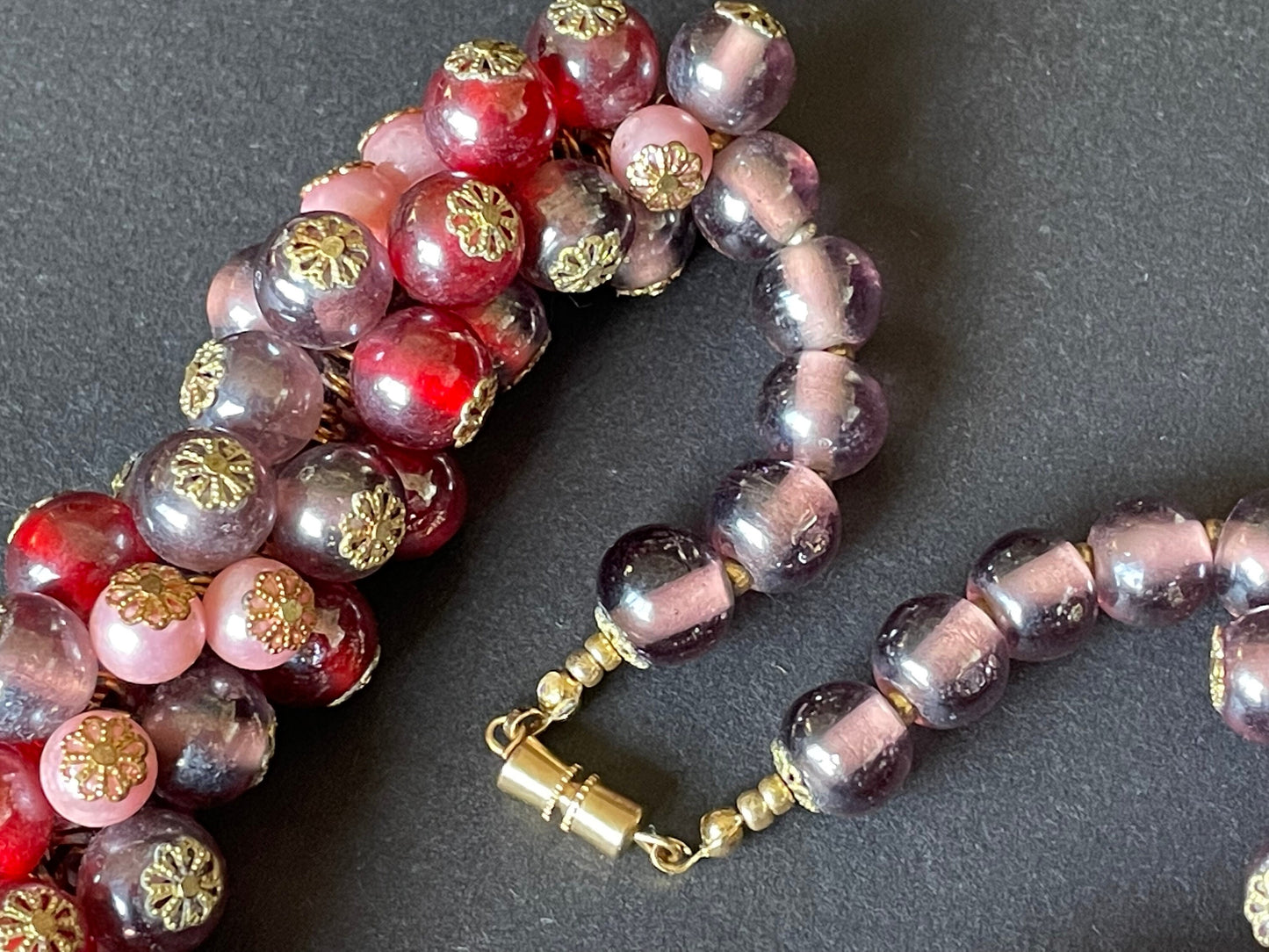 Heavy vintage pink, dark pink, purple and faux pearl glass bead cluster garland necklace with gold tone filigree bead caps and screw clasp