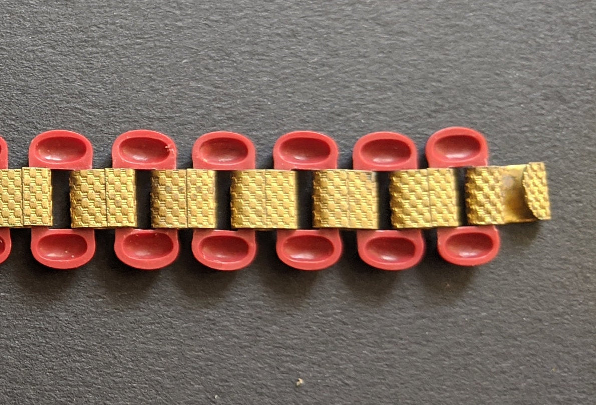 Vintage Art Deco red early plastic and tank track machine age gold tone repousse panel bracelet