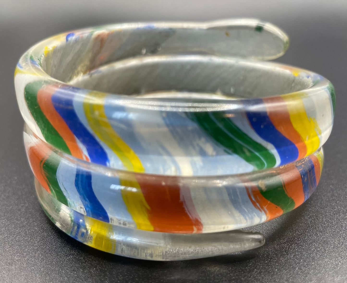 Vintage Art Deco 1920s to 1930s rainbow painted, clear celluloid spiral snake bangle bracelet, blue rhinestone eyes