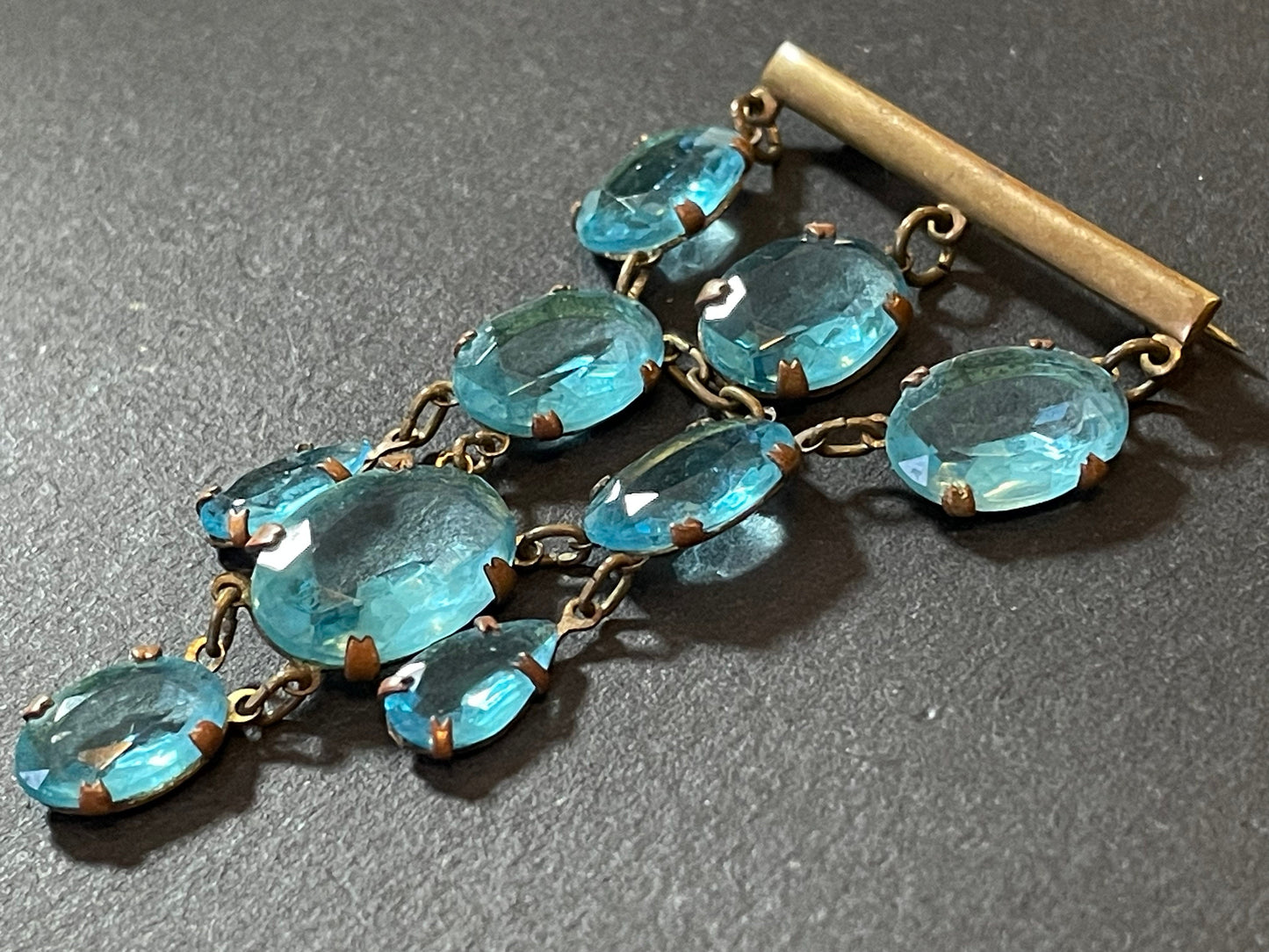 Vintage Art Deco aqua blue paste festoon dangle brooch with bezel set, open backed aquamarine coloured crystals set in antique gold tone