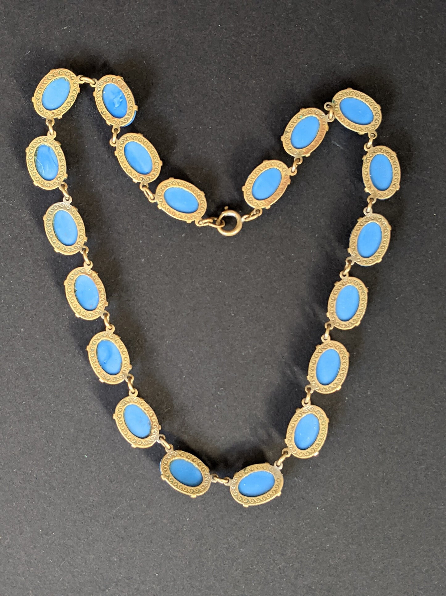 Vintage Art Deco bezel set royal blue moulded glass cabochon riviere necklace, open-backed settings in pretty engraved gold tone, 1920s-30s