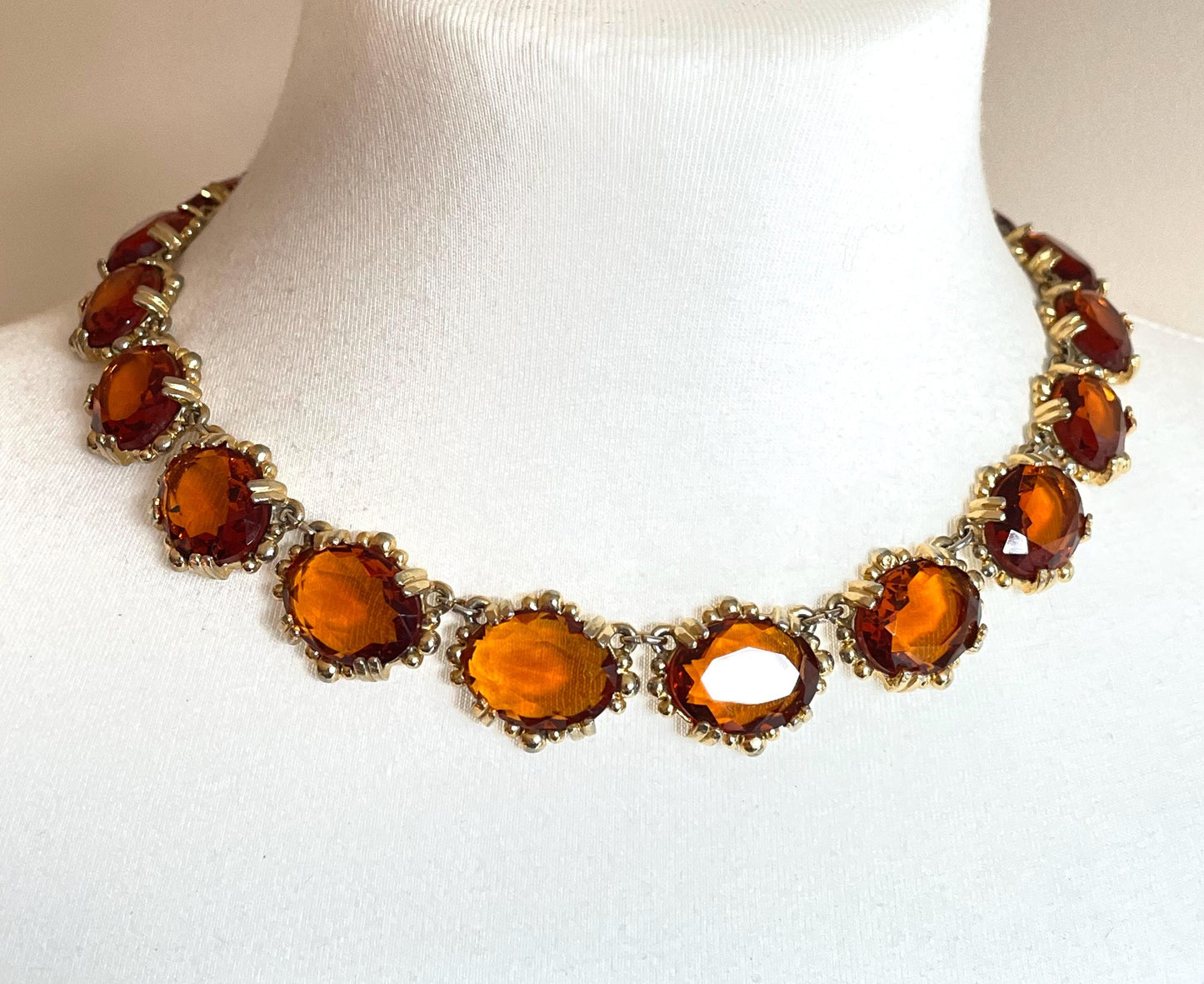 Vintage bright orange topaz / citrine yellow riviere necklace, made by Sphinx, bezel set, open-backed stones in ornate gold tone setting