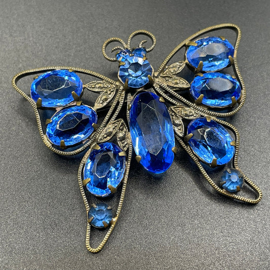 Vintage Art Deco butterfly brooch, sapphire blue glass rhinestones, set open-backed in antique gold tone Czech filigree