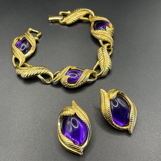 Vintage signed Trifari TM purple acrylic cabochon and gold tone bracelet and clip on earrings set, organic leaf design