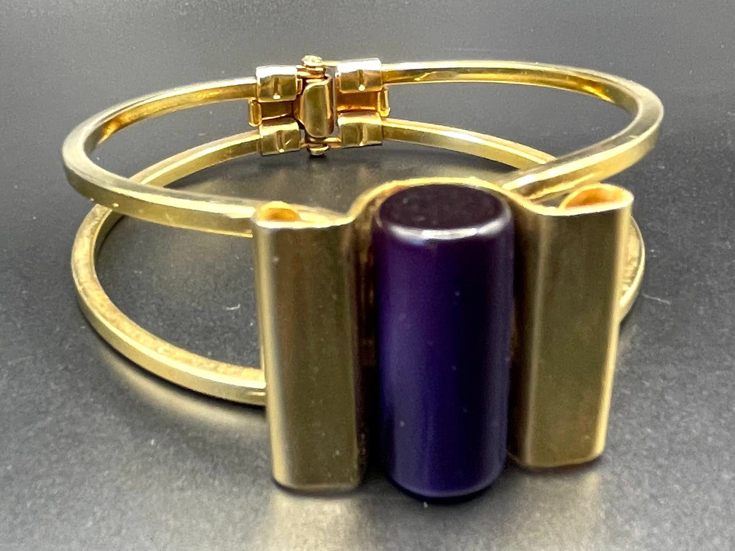 Vintage Jakob Bengel Art Deco machine age clamper bangle in shiny gold tone with a deep purple galalith cylinder