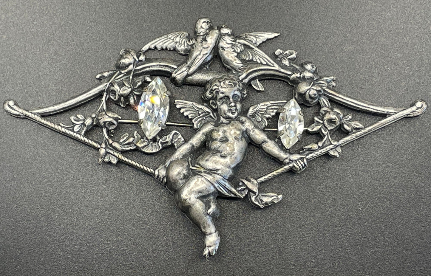 Large early Askew London, vintage cupid brooch in antique silver tone with marquise cut clear rhinestones, cherub / putti & love bird design