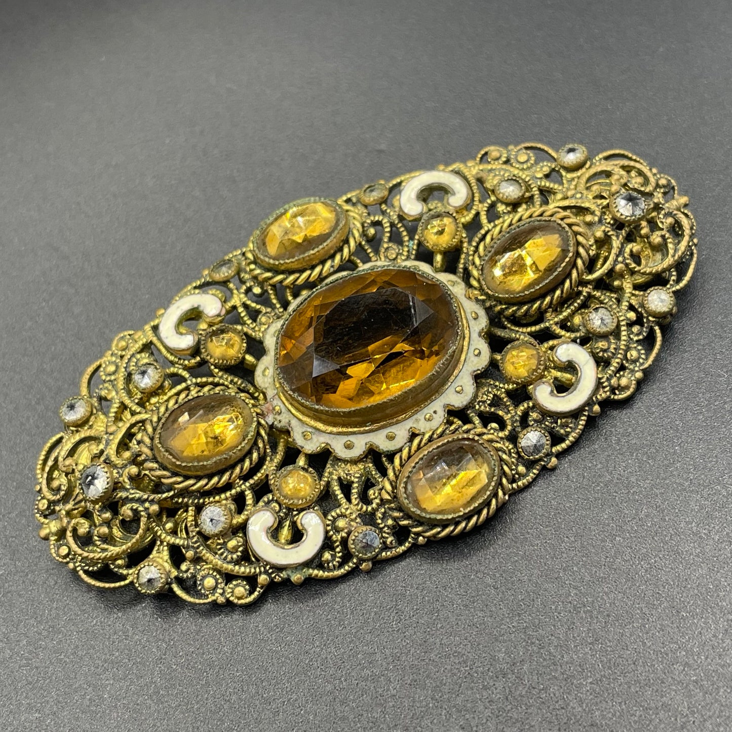 Large vintage Neiger brothers Art Deco citrine / topaz orange paste rhinestone, marcasite and white enamel brooch in gold tone filigree