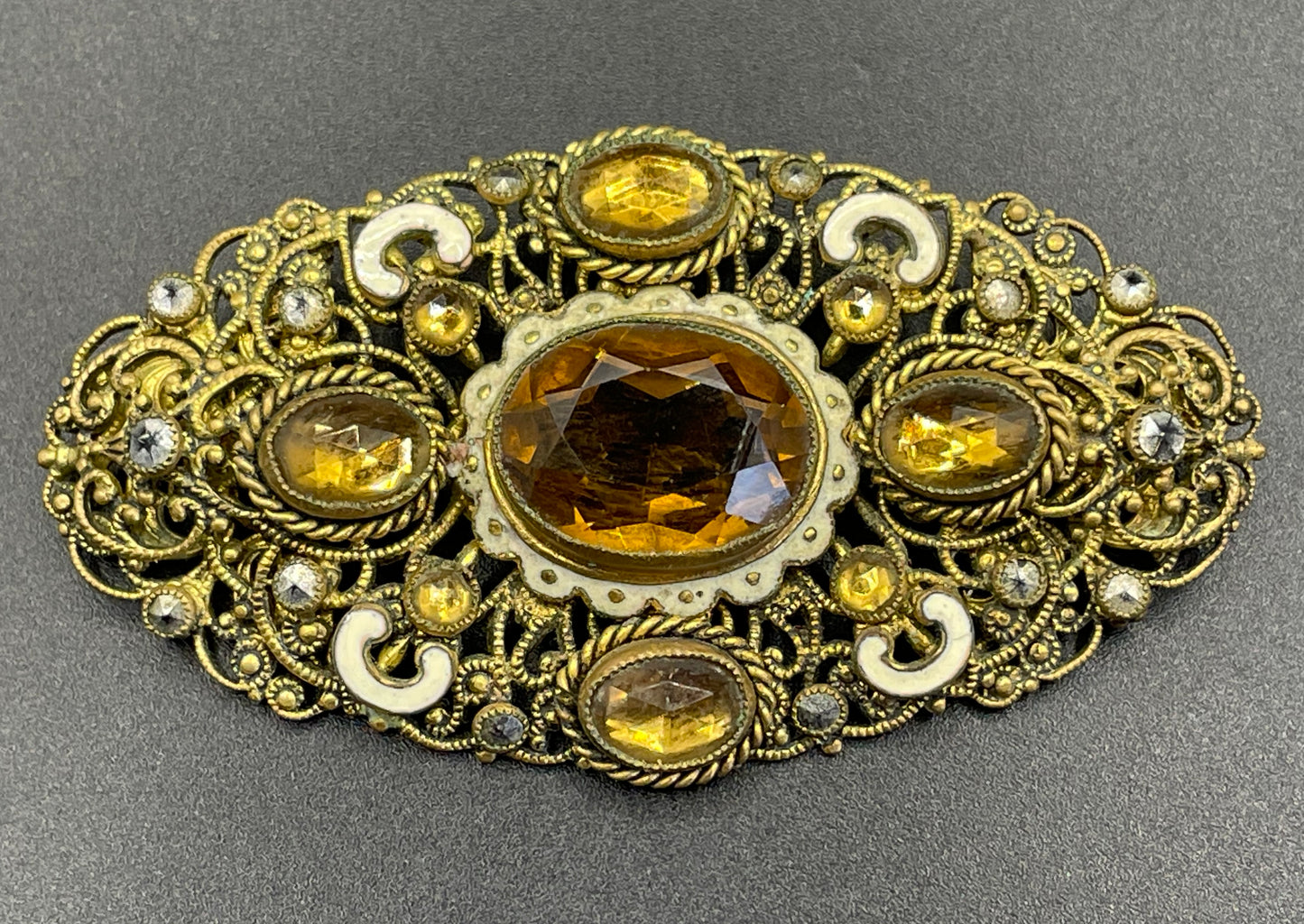 Large vintage Neiger brothers Art Deco citrine / topaz orange paste rhinestone, marcasite and white enamel brooch in gold tone filigree