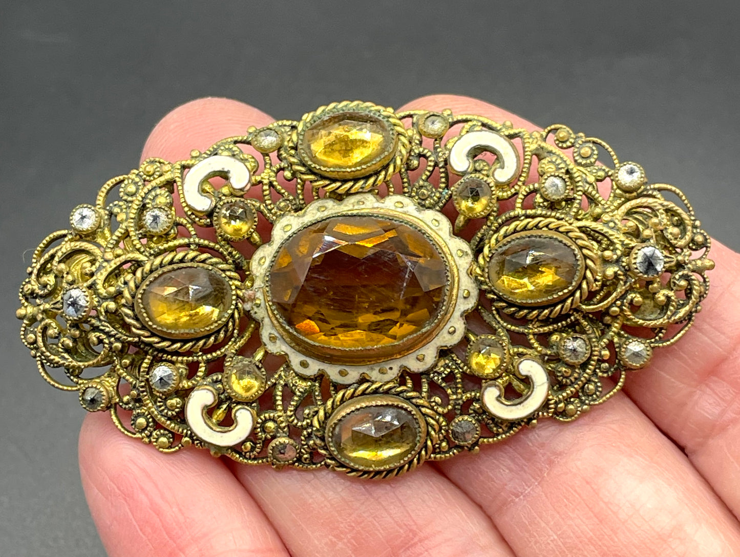 Large vintage Neiger brothers Art Deco citrine / topaz orange paste rhinestone, marcasite and white enamel brooch in gold tone filigree